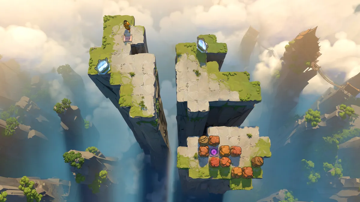 Two rock pillars rising out of the mist, with mirrors and boulders on top